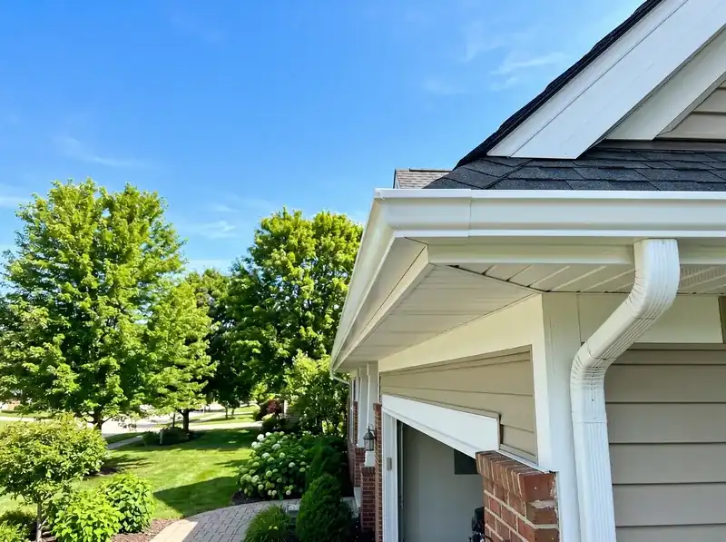 Clean white gutters and soffit on a bright suburban home