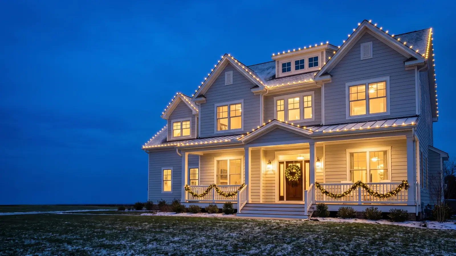 Eastern Shore home at dusk with warm-white professional Christmas lights along its rooflines, installed by Terrapin Pro Wash