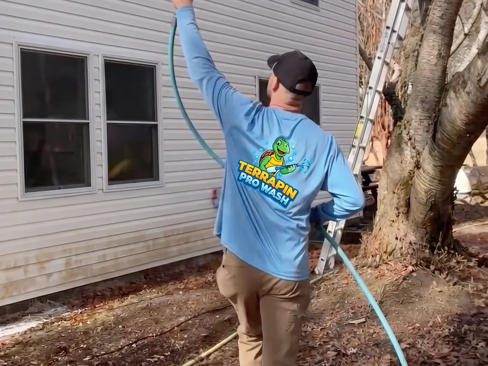 Terrapin Pro Wash technician in branded uniform soft washing house siding
